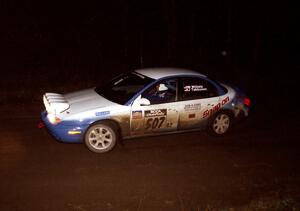 Micah Wiitala / Jason Takkunen set up for a sweeping left at night in their Saturn SL2.