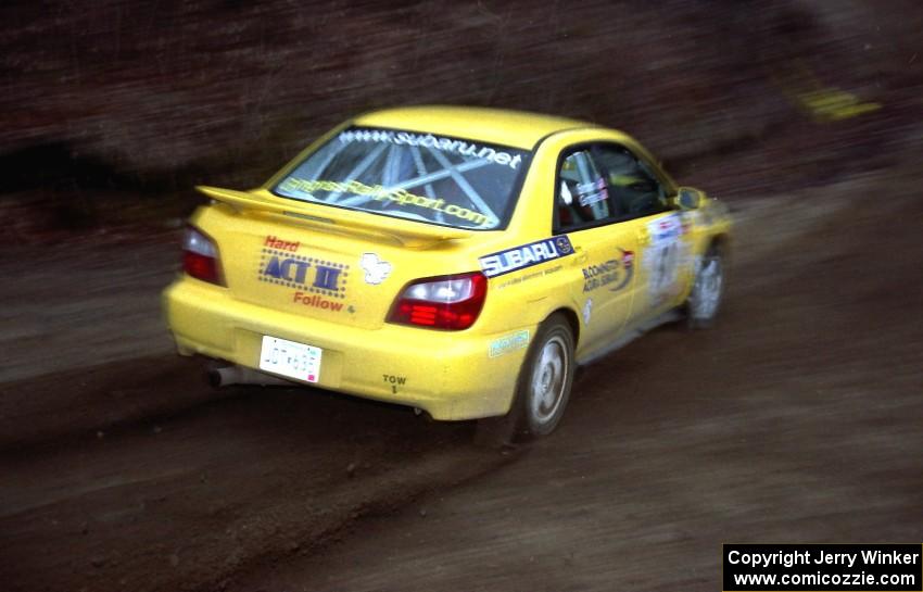 Steve Gingras / Phil Strohm drift their Subaru WRX through a fast sweeper on SS1.