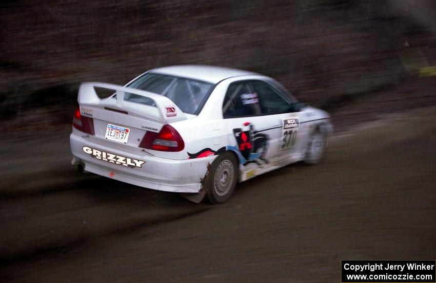 Brian Scott / David Watts drift through a sweeper on SS1 in their Mitsubishi Lancer Evo IV.