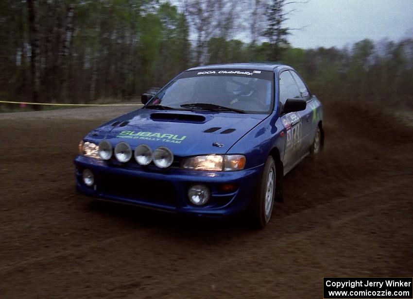 Kazimierz Pudelek / Mark Pudoluch drift through a 90-left on SS2 in their Subaru Impreza.