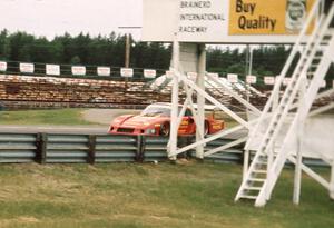 Gianpiero Moretti comes past the start/finish in his Porsche 935 during Friday afternoon practice.