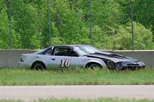 David Henderson's American Sedan Chevy Camaro crashed into the wall at turn 2A.