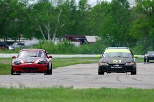 Wade Roggemann's ITJ Honda Civic passes John Elder's STL Mazda Miata