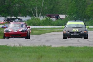Wade Roggemann's ITJ Honda Civic passes John Elder's STL Mazda Miata
