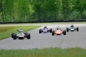 Five vintage Formula Fords come into turn 4.