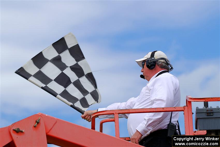 The checkered flag waves for the finish of the Spec Racer Ford 3 race.