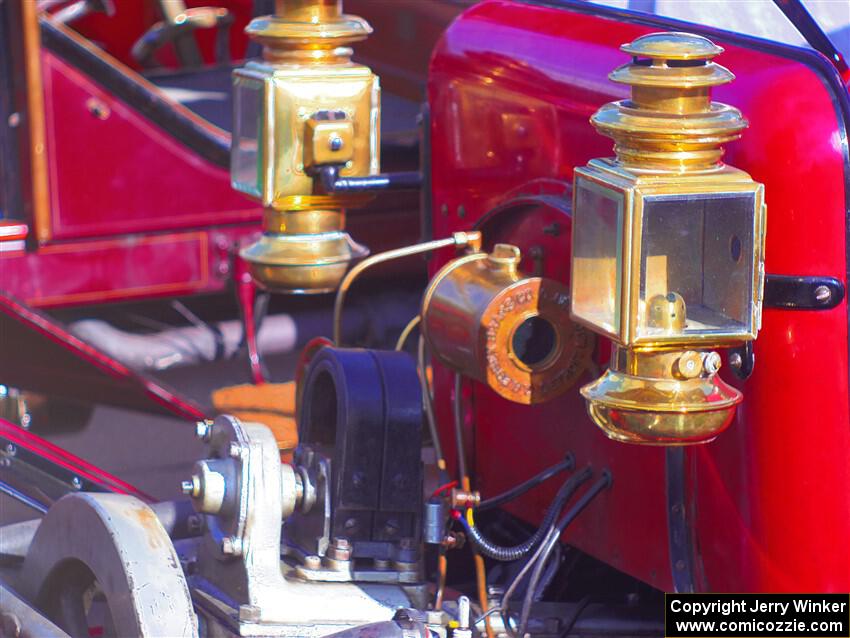 Headlamps on an antique car.