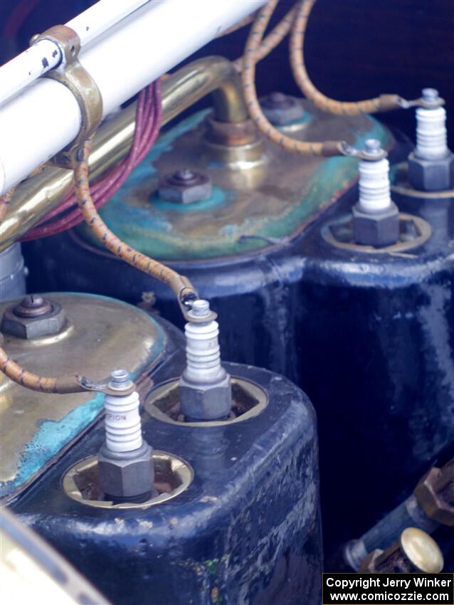 Spark plugs and wires on an antique car.
