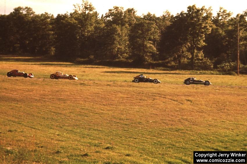 David Harris (Lynx B) leads Jerry Knapp (Caldwell D-13), Steve Thomson (Lynx B) and C. Fred Clark (Lynx B) through turn 6.