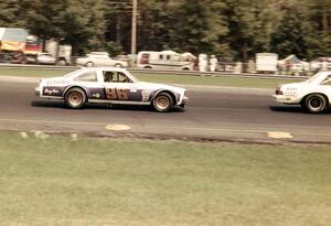 Gene Felton's Chevy Nova chases Vern Smith's Olds Cutlass in the Kelly American Challenge race.