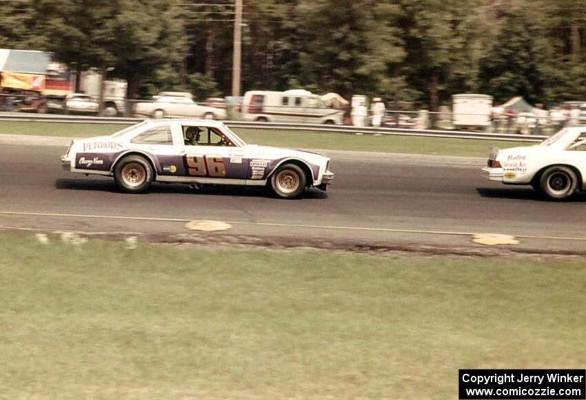Gene Felton's Chevy Nova chases Vern Smith's Olds Cutlass in the Kelly American Challenge race.