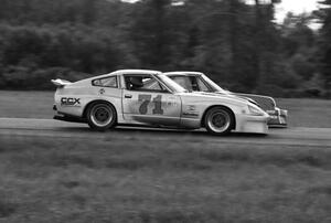 Charles Morgan's Datsun 280ZX and Bill Koll's Porsche 911 go side-by-side into turn four.