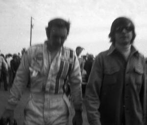 Peter Revson walks back to the pits after retiring.