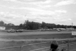 Three cars head down the front straight early on during the race.