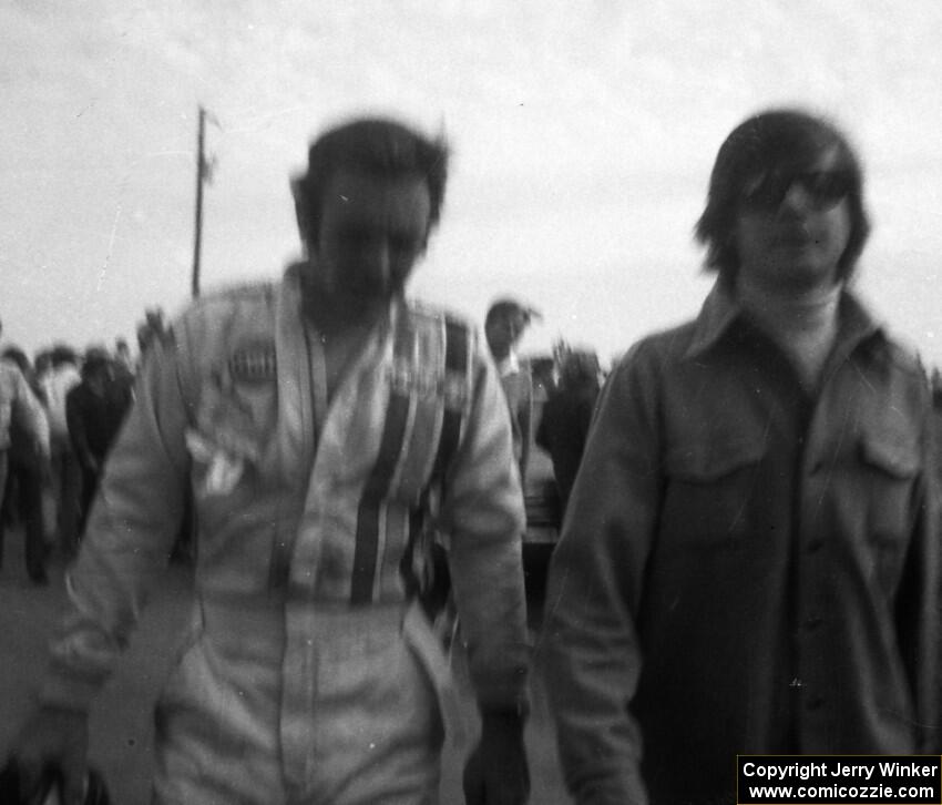 Peter Revson walks back to the pits after retiring.