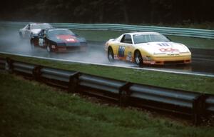 Clay Young - Pontiac Firebird leads Tim Selby - Chevy Camaro and the Scott Flatt / Rob Dyson - Chevy Camaro (IMSA Kelly AC race)