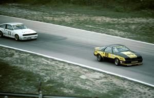 Kal Showket - Dodge Daytona leads Tommy Archer - Chevy Cavalier RS (IMSA RS race)