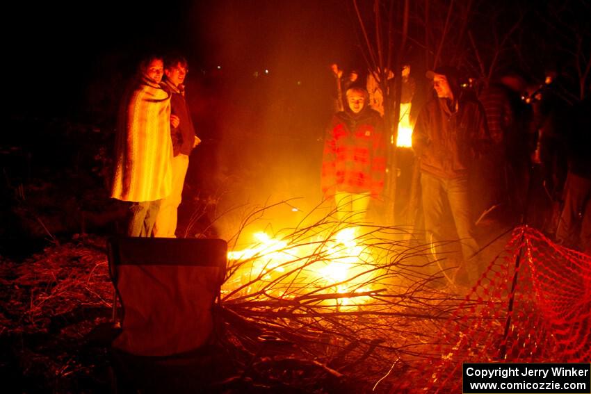 Rally fans around a bonfire at the finish of SS6, Quinnan-Sage Creek II.