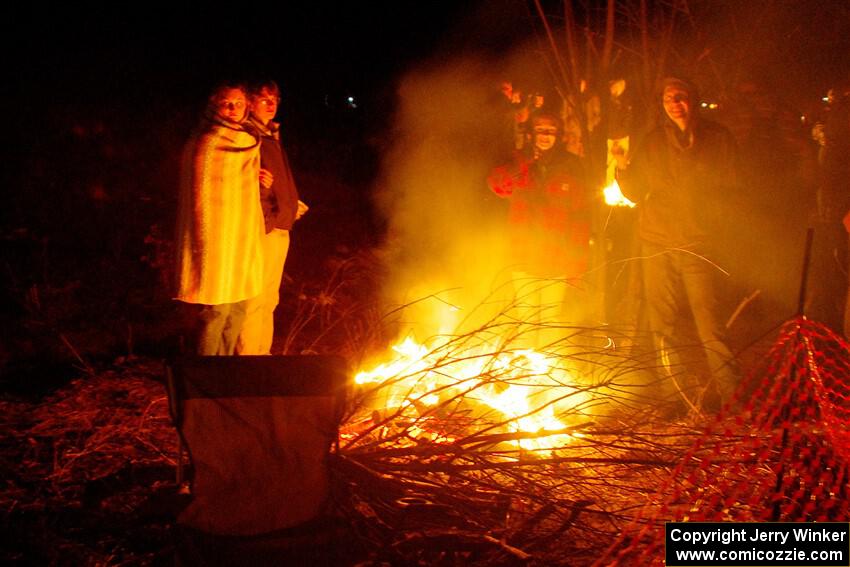 Rally fans around a bonfire at the finish of SS6, Quinnan-Sage Creek II.