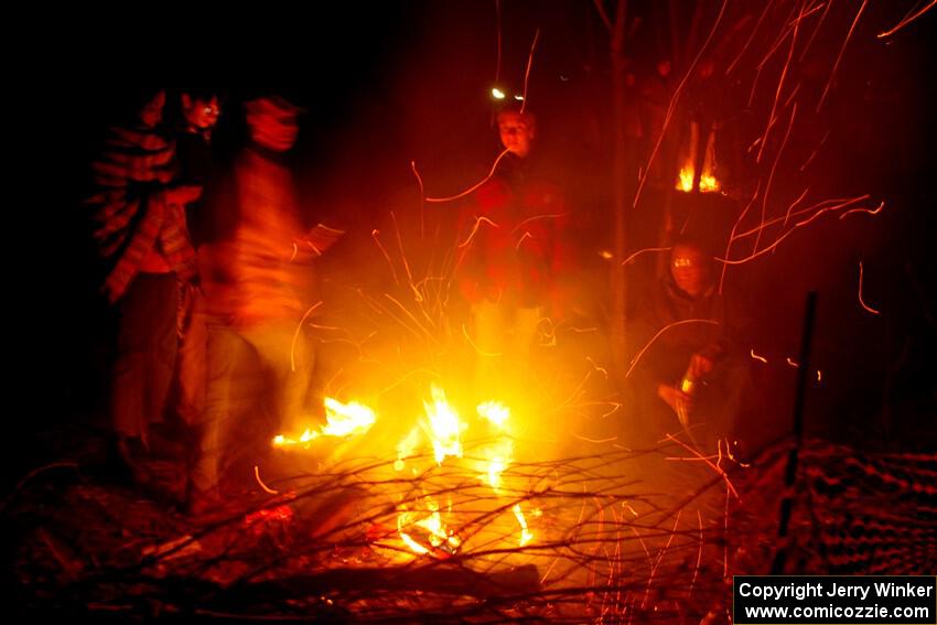 Rally fans around a bonfire at the finish of SS6, Quinnan-Sage Creek II.