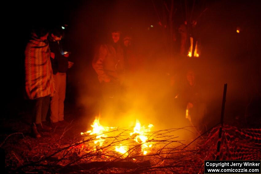 Rally fans around a bonfire at the finish of SS6, Quinnan-Sage Creek II.