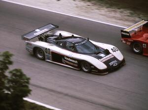 David Hobbs / Sarel van der Merwe - Chevrolet Corvette GTP make a pass on a camel Lights car exiting the carousel.