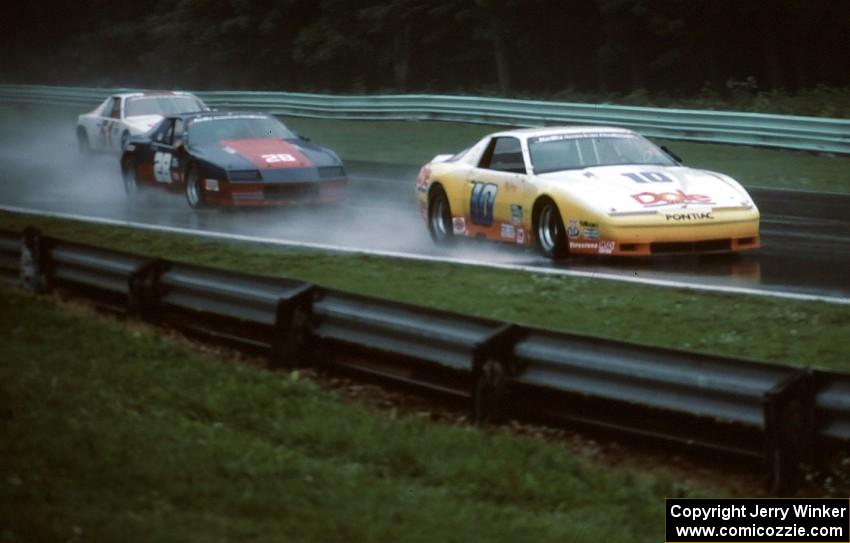 Clay Young - Pontiac Firebird leads Tim Selby - Chevy Camaro and the Scott Flatt / Rob Dyson - Chevy Camaro (IMSA Kelly AC race)