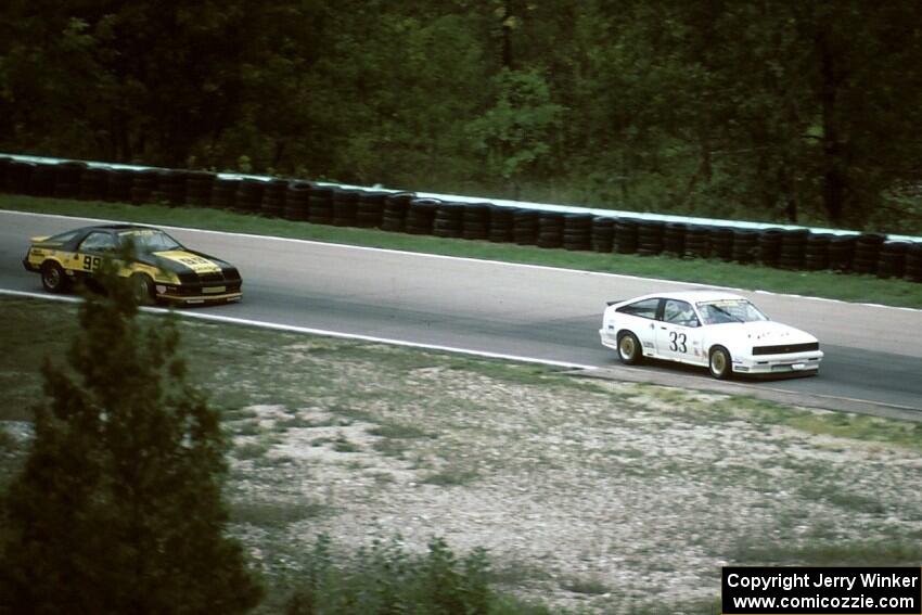 Tommy Archer - Chevy Cavalier RS leads Kal Showket - Dodge Daytona (IMSA RS race)