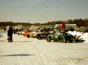 Cars lined up along the pit wall