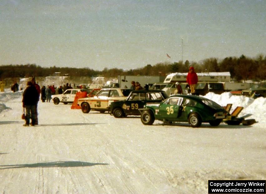 Cars lined up along the pit wall