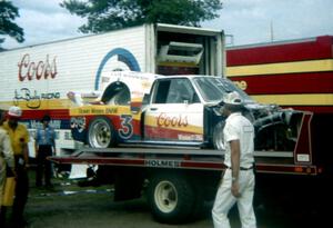 Jim Busby's BMW 320i Turbo comes in on the flatbed after a horrific fire during the race.