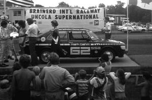 Mark Behm is handed his trophy after winning SSA in his SAAB Turbo.