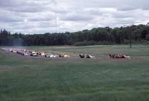 The field heads through turns three and four on the pace lap.