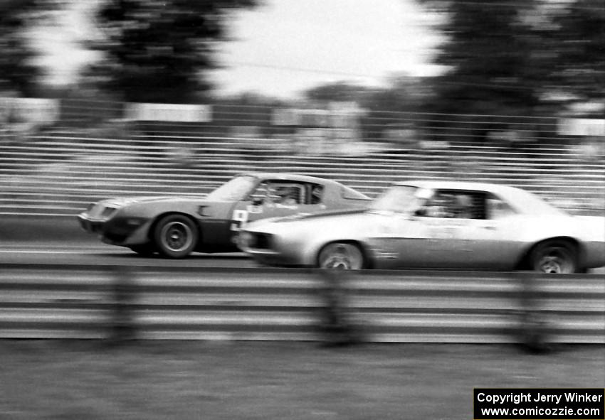 Al Mumaugh's Pontiac Trans-Am is passed by Al Ratcliff's Chevy Camaro.