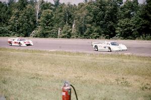 Bob Tullius/ Bill Adam Jaguar XJR-5 leads the Dave Cowart / Kenper Miller March 83G/Chevrolet through turn 1.