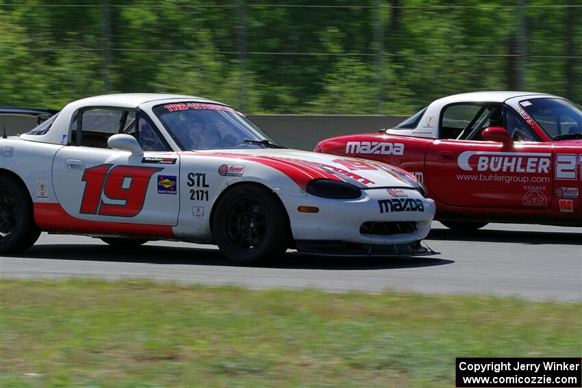 Nolan Elder's STL Mazda Miata passes Andrew Jenkins' Spec Miata Mazda Miata