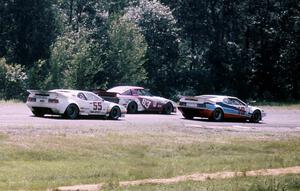 "Fomfor"'s BMW M-1, the Jim Downing / John Maffucci Mazda RX-7 and Diego Montoya's BMW M-1 head into turn 9.