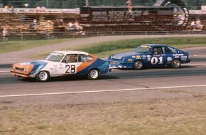 Ralph Schreyer's Mercury Capri II about to be passed by Joe Varde's Dodge Charger on the front straight.