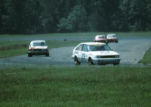 Tom Schneider's Nissan Stanza leads John Poulos's BMW 320i, Ron Tambourine's Mazda RX-3 and Ralph Schreyer's Mercury Capri II.