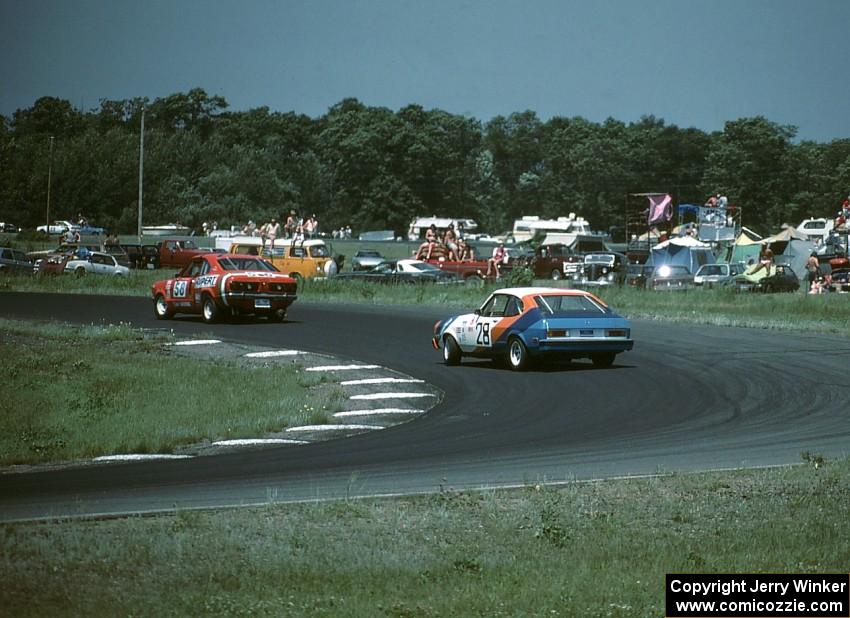 Ron Tambourine's Mazda RX-3 leads Ralph Schreyer's Mercury Capri II through turn 4.