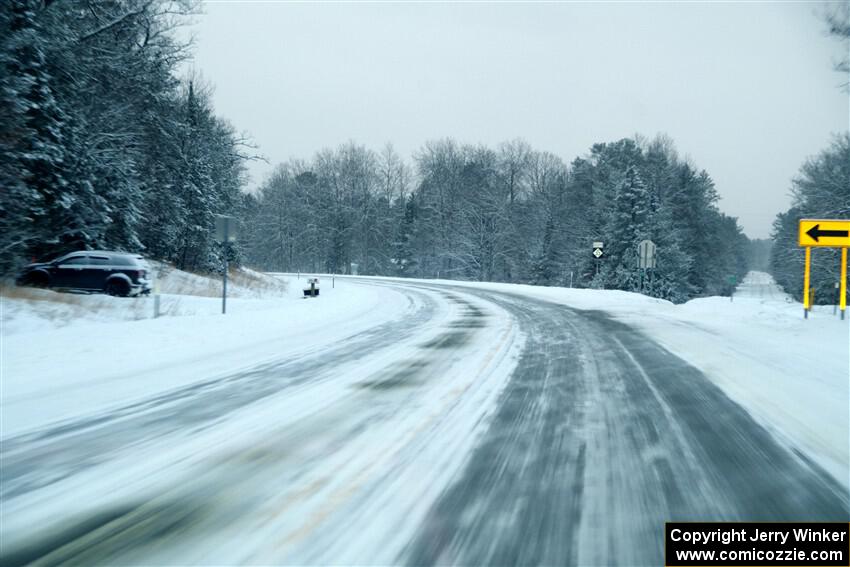 Falling snow blows over the road leaving Atlanta, MI.