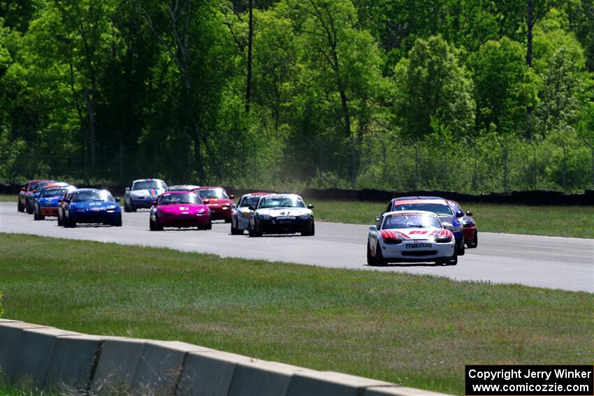 The small-bore field on the first lap of the race between turns 3 and 4.