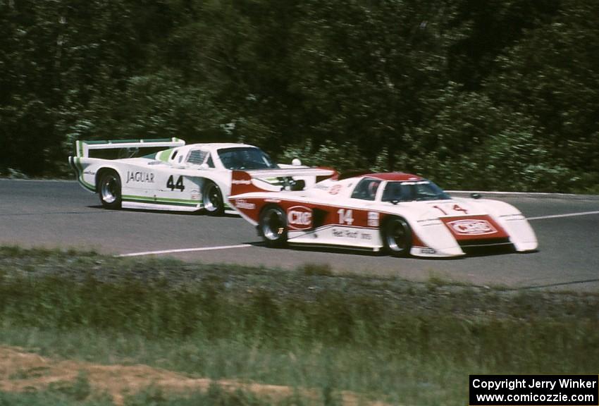 The Al Holbert / Jim Trueman March 83G/Porsche leads the Bob Tullius / Bill Adam Jaguar XJR-5 into turn 1 on lap 1.