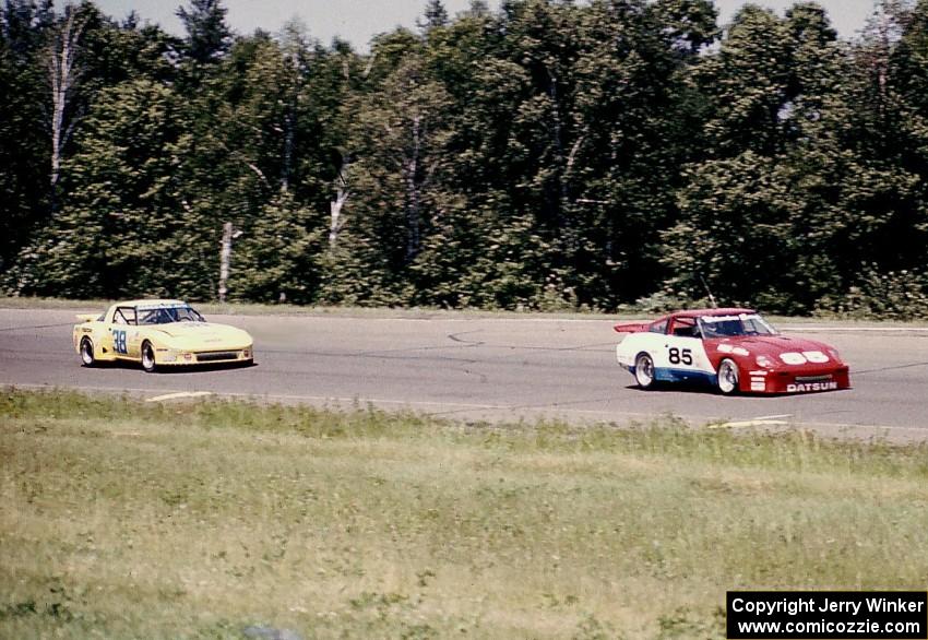 Logan Blackburn's Datsun 280XZ leads the Roger Mandeville / Amos Johnson Mazda RX-7 through turn 1.