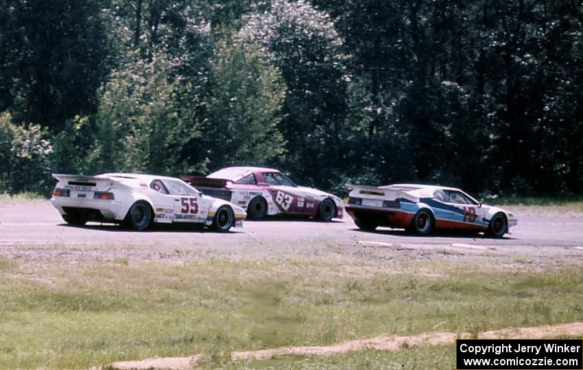 "Fomfor"'s BMW M-1, the Jim Downing / John Maffucci Mazda RX-7 and Diego Montoya's BMW M-1 head into turn 9.