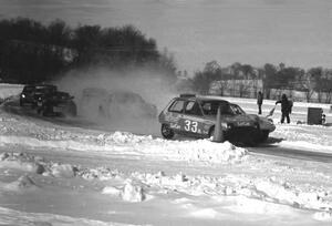 Tommy Archer's Renault LeCar leads Steve Erickson's SAAB Sonett II and the rest into turn one on the first lap.