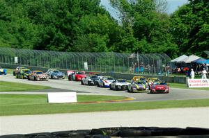 Mazda MX-5 Cups stream into turn 3 on lap one, with Selin Rollan and Michael Carter leading the way.