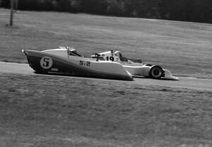 John Cahill's Ocelot 79 Sports 2000 is passed by Ray Schuler's March 78B Formula Atlantic in turn 4.