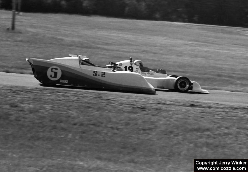 John Cahill's Ocelot 79 Sports 2000 is passed by Ray Schuler's March 78B Formula Atlantic in turn 4.