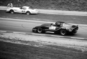 Phil Currin's Chevy Corvette laps the stopped Chevy Corvette of Larry Gross.